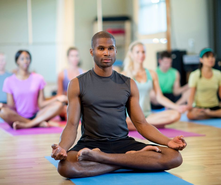 Yoga Instructor and students in lotus position