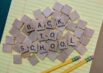 Back to School spelled with scrabble pieces on yellow notepad. 