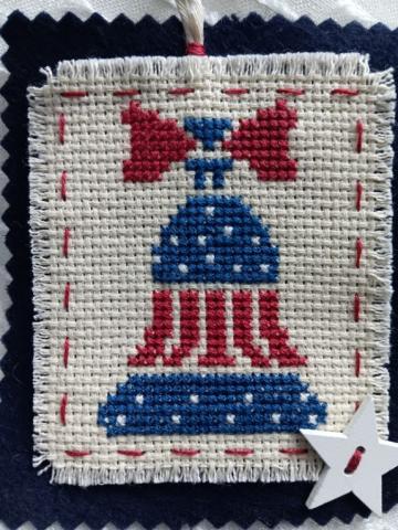 cross stitch of a red, white and blue bell