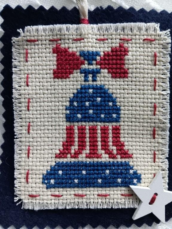 cross stitch of a red, white and blue bell